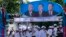Supporters of Prime Minister Hun Sen's Cambodian People's Party dance under portraits of the party leaders, from left, Chea Sim, Hun Sen and Heng Samrin, during an election campaign in Phnom Penh, Cambodia, Thursday, June 27, 2013. Cambodia's political parties on Thursday kicked off campaigning for the July 28 general election, which is almost certain to see the return to power of Asia's longest-serving leader, Hun Sen.