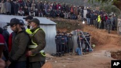 Residents watch in concern as civil defense and local authorities dig in a hill as they attempt to rescue a 5 year old boy who fell into a hole near the town of Bab Berred near Chefchaouen, Morocco, Feb. 3, 2022.