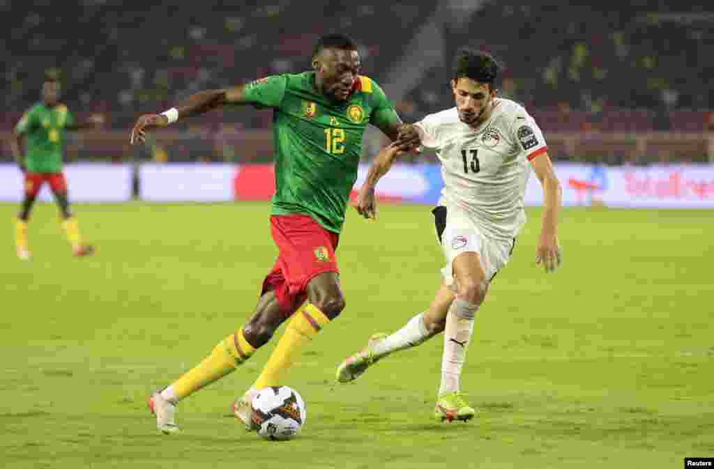 Cameroon&#39;s Karl Toko-Ekambi in action with Egypt&#39;s Ahmed Fatouh, Feb. 3, 2022.