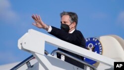 FILE - U.S. Secretary of State Antony Blinken waves as he departs for a foreign trip, at Andrews Air Force Base, Maryland, Jan. 18, 2022.