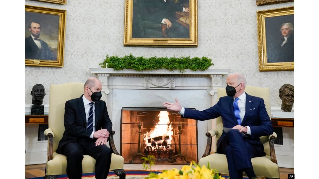 FILE - President Joe Biden, right, gestures during a meeting with German Chancellor Olaf Scholz in the Oval Office of the White House, in Washington, Feb. 7, 2022.