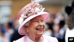 FILE - Britain's Queen Elizabeth arrives for a Royal Garden Party at Buckingham Palace in London, May 29, 2019.