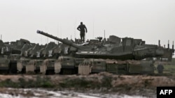 FILE - Israeli Merkava battle tanks are stationed during a military drill in the Israel-annexed Golan Heights, Jan. 31, 2022. 