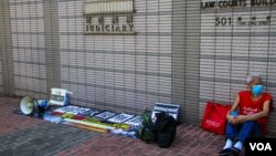 FILE - Koo Sze-yiu sits outside West Kowloon court, Kowloon, Hong Kong, October 15, 2020 (Tommy Walker/VOA)