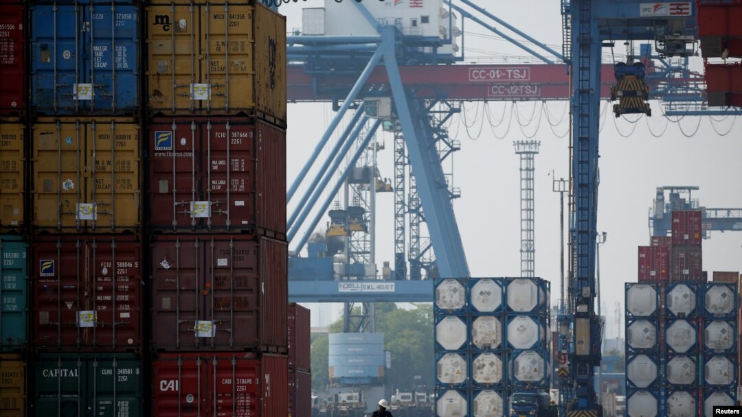 Ilustrasi - Seorang pekerja mengendarai sepeda motor melewati tumpukan peti kemas di Terminal Peti Kemas IPC pelabuhan Tanjung Priok di Jakarta, 4 November 2021. REUTERS/Willy Kurniawan