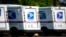 FILE - United States Postal Service delivery vans sit outside a post office in Greeley, Colo., July 26, 2021. 