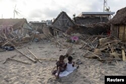 Children sit outside their destroyed house, in the aftermath of Cyclone Batsirai, in the town of Mananjary, Madagascar, Feb. 7, 2022.