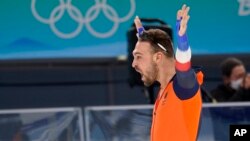 Kjeld Nuis of the Netherlands celebrates after breaking an Olympic record during the men's speedskating 1,500-meter race, Feb. 8, 2022.