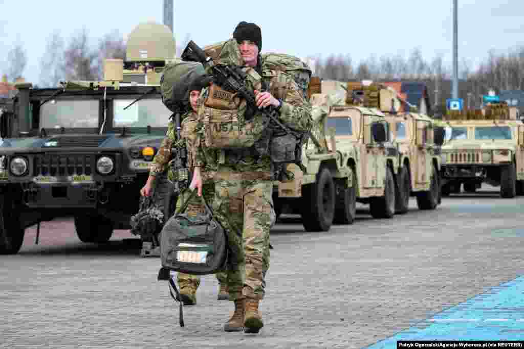 U.S. soldiers from the 82nd Airborne Division walk near the G2A Arena following their arrival at Rzeszow-Jasionka Airport, in Jasionka, Poland.
