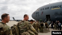 Military personnel from the 82nd Airborne Division and 18th Airborne Corps board a C-17 transport plane for deployment to Eastern Europe, amid escalating tensions between Ukraine and Russia, at Fort Bragg, North Carolina, Feb. 3, 2022.