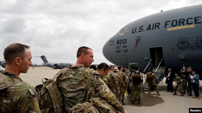 Military personnel from the 82nd Airborne Division and 18th Airborne Corps board a C-17 transport plane for deployment to Eastern Europe, amid escalating tensions between Ukraine and Russia, at Fort Bragg, North Carolina, Feb. 3, 2022.