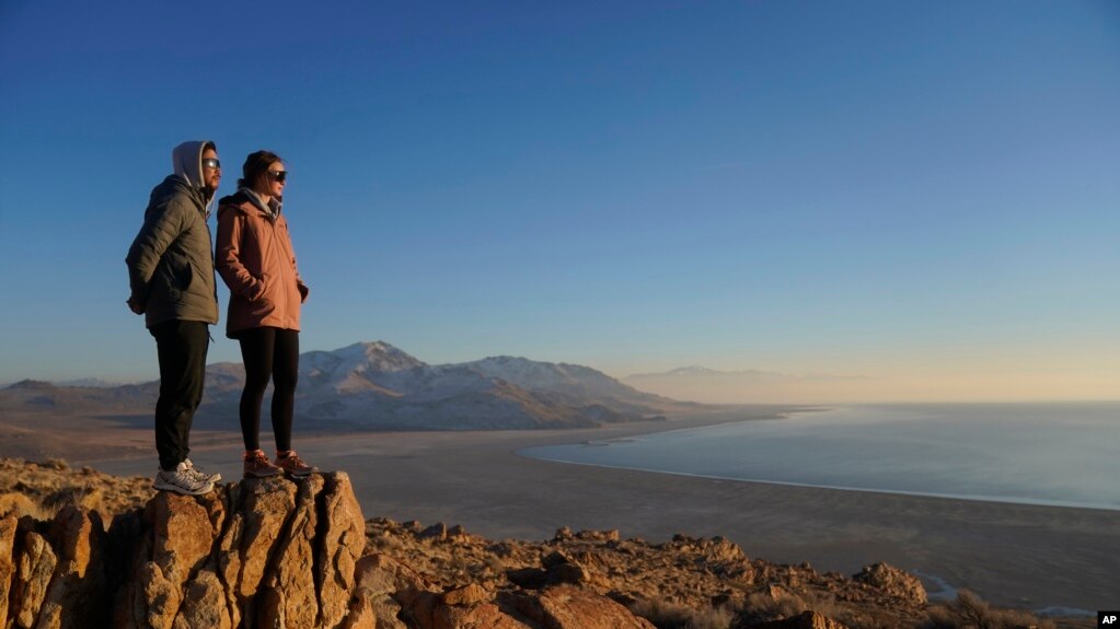 Antelope Island State Park visitors view the the receding edge of the Great Salt Lake Friday, Jan. 28, 2022, at Antelope Island, Utah. (AP Photo/Rick Bowmer)