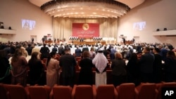 FILE - Newly elected lawmakers attend their first parliament session, in Baghdad, Iraq, Jan. 9, 2022. (Iraqi Parliament Media Office via AP) 