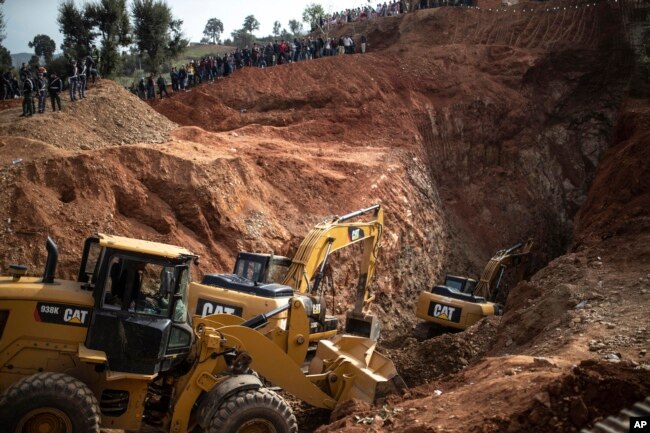 Tractors dig a trench as part of a operation to rescue a 5-year-old boy who fell into a well in Ighran, Morocco, Feb. 4, 2022.