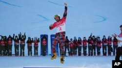 Gold medalist Austria's Benjamin Karl celebrates after winning gold in the men's parallel giant slalom, Feb. 8, 2022, in Zhangjiakou, China.
