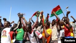 FILE - People gather in support of a coup that ousted President Roch Kabore, dissolved government, suspended the constitution and closed borders in Burkina Faso, Ouagadougou, Jan. 25, 2022.