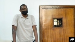 FILE - Ugandan author Kakwenza Rukirabashaija appears before a court in a failed bid to have his passport returned, in Kampala, Uganda, Feb. 1, 2022.
