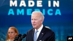 President Joe Biden speaks about domestic manufacturing and electric vehicle chargers while accompanied by Tritium CEO Jane Hunter in the South Court Auditorium in the Eisenhower Executive Office Building on the White House complex, Feb. 8, 2022.