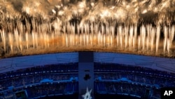 Fireworks light up the sky over Olympic Stadium during the opening ceremony of the 2022 Winter Olympics, Friday, Feb. 4, 2022, in Beijing. (AP Photo/Jeff Roberson)