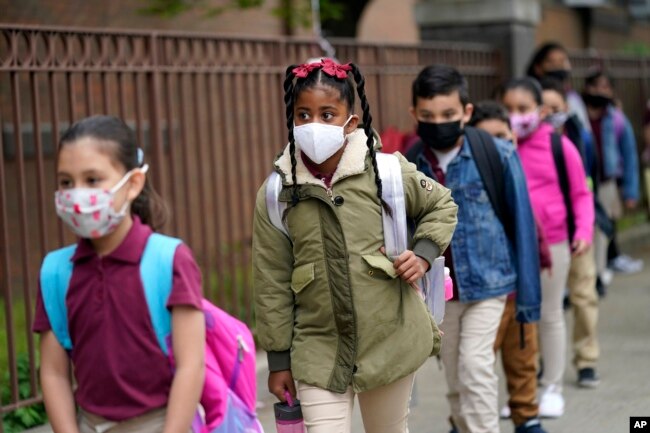 FILE - Students line up to enter Christa McAuliffe School in Jersey City, New Jersey, April 29, 2021.
