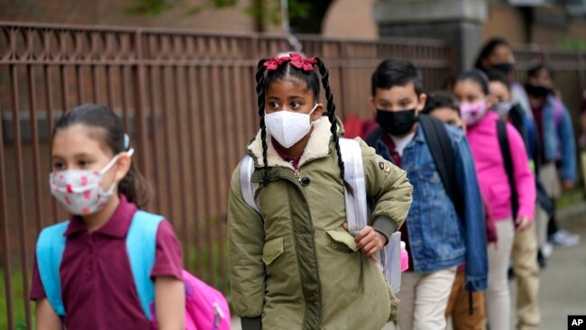 FILE - Students line up to enter Christa McAuliffe School in Jersey City, N.J., April 29, 2021.