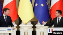 Ukrainian President Volodymyr Zelenskiy and French President Emmanuel Macron attend a news briefing following their talks in Kyiv, Feb. 8, 2022.