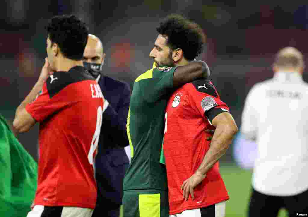 Egypt&#39;s Mohamed Salah is being consoled by a Senegalese player after losing the Africa Cup of Nations in Cameroon, Feb. 6, 2022.