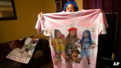 Katrina Lambert holds up a shirt she was given after her daughter Todriana Peters was killed in New Orleans, July 8, 2021. Todriana Peters, 12, was shot and killed outside a graduation party on Memorial Day Weekend.