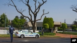 FILE - A policeman walks outside the U.S. Embassy in Pretoria, South Africa, Sept. 22, 2009.