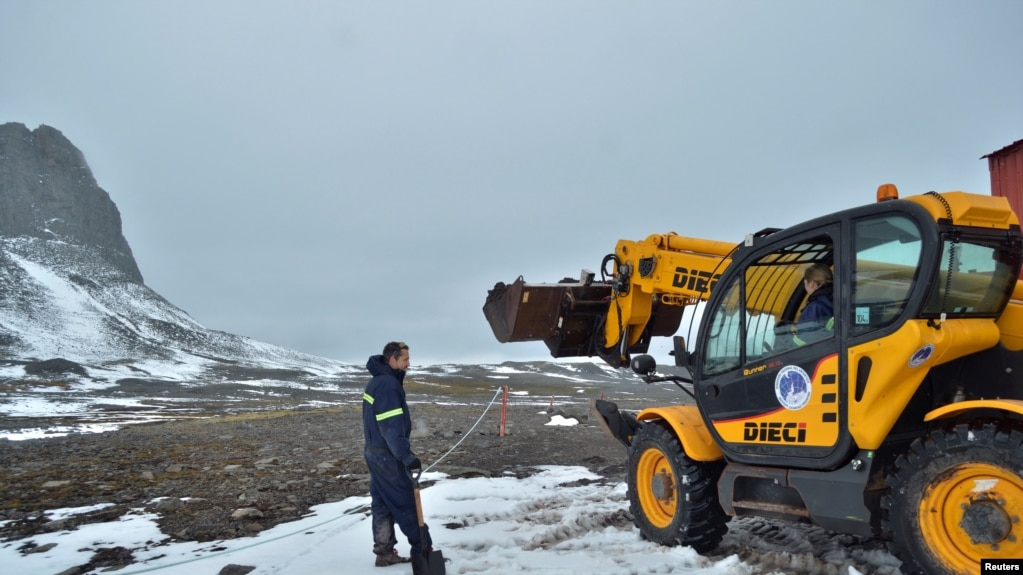 Argentine scientists prepare the soil before taking samples of it using native microorganisms to clean up pollution from fuels and potentially plastics. Nicolas Chiarada/Handout via REUTERS