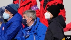 China's Peng Shuai (R), watches the women's freestyle skiing big air finals with Thomas Bach (C) IOC President, Feb. 8, 2022, in Beijing.