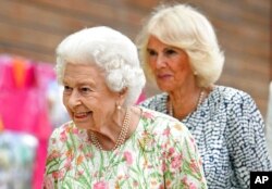 FILE - Britain's Queen Elizabeth II and Camilla, Duchess of Cornwall, at the G7 summit in Cornwall, England, June 11, 2021.