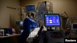 Medical staff treat a COVID-19 patient in the Intensive Care Unit at the Providence Mission Hospital in Mission Viejo, California, Jan. 25, 2022.