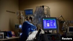 Medical staff treat a COVID-19 patient in the Intensive Care Unit at the Providence Mission Hospital in Mission Viejo, California, Jan. 25, 2022.