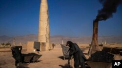 FILE - Afghan laborers work at a brick factory in Deh Sabz, on the outskirts of Kabul, Sept. 26, 2021. With Afghan assets frozen in the U.S. and the world reluctant to recognize the Taliban, the country's banking system has come to a halt.