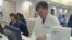 A doctor accesses personalized healthcare information for patients on a computer, February 2011