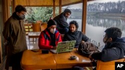 FILE - Kashmiri journalists prepare for a meeting to discuss the shutting of Kashmir Press Club building, the region’s only independent press club, in Srinagar, Indian-controlled Kashmir, Jan. 20, 2022.
