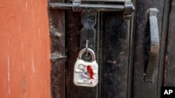 FILE - A sealed lock hangs at the gate of the closed Kashmir Press Club building in Srinagar, Indian-controlled Kashmir, Jan. 18, 2022. 