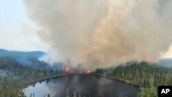 In this image released by the Ontario Ministry of Natural Resources and Forestry, the Chapleau 3 wildfire burns near the township of Chapleau, Ontario, on June 4, 2023