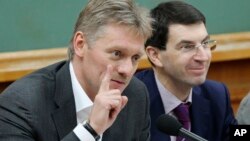 FILE - Kremlin spokesman Dmitry Peskov (L) is seen speaking during a meeting in Moscow, Russia.