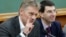 FILE - Russian President Vladimir Putin's spokesman Dmitry Peskov, left, speaks during a meeting in Moscow, Russia. 