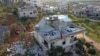 People inspect a destroyed house following a U.S. military operation in Atmeh, Syria, Feb. 3, 2022. Islamic State leader Amir Muhammad Sa'id Abdal-Rahman al-Mawla was killed in the raid.
