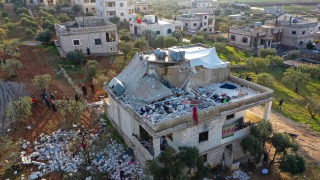 People inspect a destroyed house following a U.S. military operation in Atmeh, Syria, Feb. 3, 2022. Islamic State leader Amir Muhammad Sa'id Abdal-Rahman al-Mawla was killed in the raid.