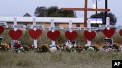 FILE - A makeshift memorial for those who were killed in the Sutherland Springs Baptist Church shooting in Texas, Nov. 10, 2017.