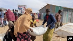 Food supplies are distributed during a visit by WFP Regional Director to a camp for the IDPs in Adadle, in the Somali Region of Ethiopia, Jan. 22, 2022. 