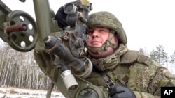 In this photo taken from video and released by the Russian Defense Ministry Press Service on Feb. 4, 2022, a soldier takes part in the Belarusian and Russian joint military drills at Brestsky firing range, Belarus.