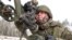 In this photo taken from video and released by the Russian Defense Ministry Press Service on Feb. 4, 2022, a soldier takes part in the Belarusian and Russian joint military drills at Brestsky firing range, Belarus.