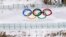 Biathletes skate above the Olympic rings during practice at the 2022 Winter Olympics, Feb. 3, 2022, in Zhangjiakou, China. 