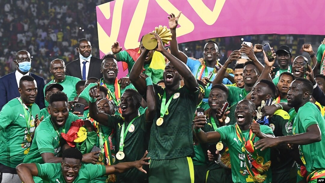 Senegal's players celebrate with the trophy after winning the Africa Cup of Nations 2021 final football match between Senegal and Egypt at Stade d'Olembe in Yaounde, Cameroon, on Feb. 6, 2022.