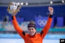 Ireen Wust of the Netherlands reacts during a flower ceremony after winning the gold medal and setting an Olympic record in the women's speedskating 1,500-meter race at the 2022 Winter Olympics, Feb. 7, 2022, in Beijing.
